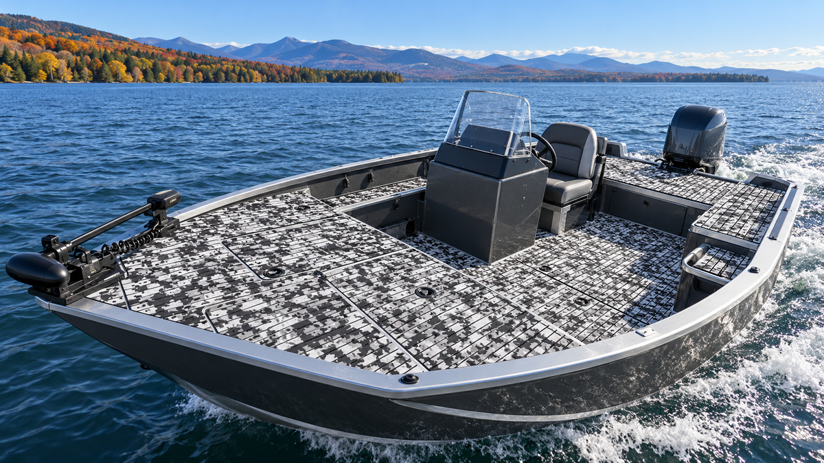 Black and white patterned flooring across the bow, cockpit, and stern decks of an aluminum fishing boat on a blue lake