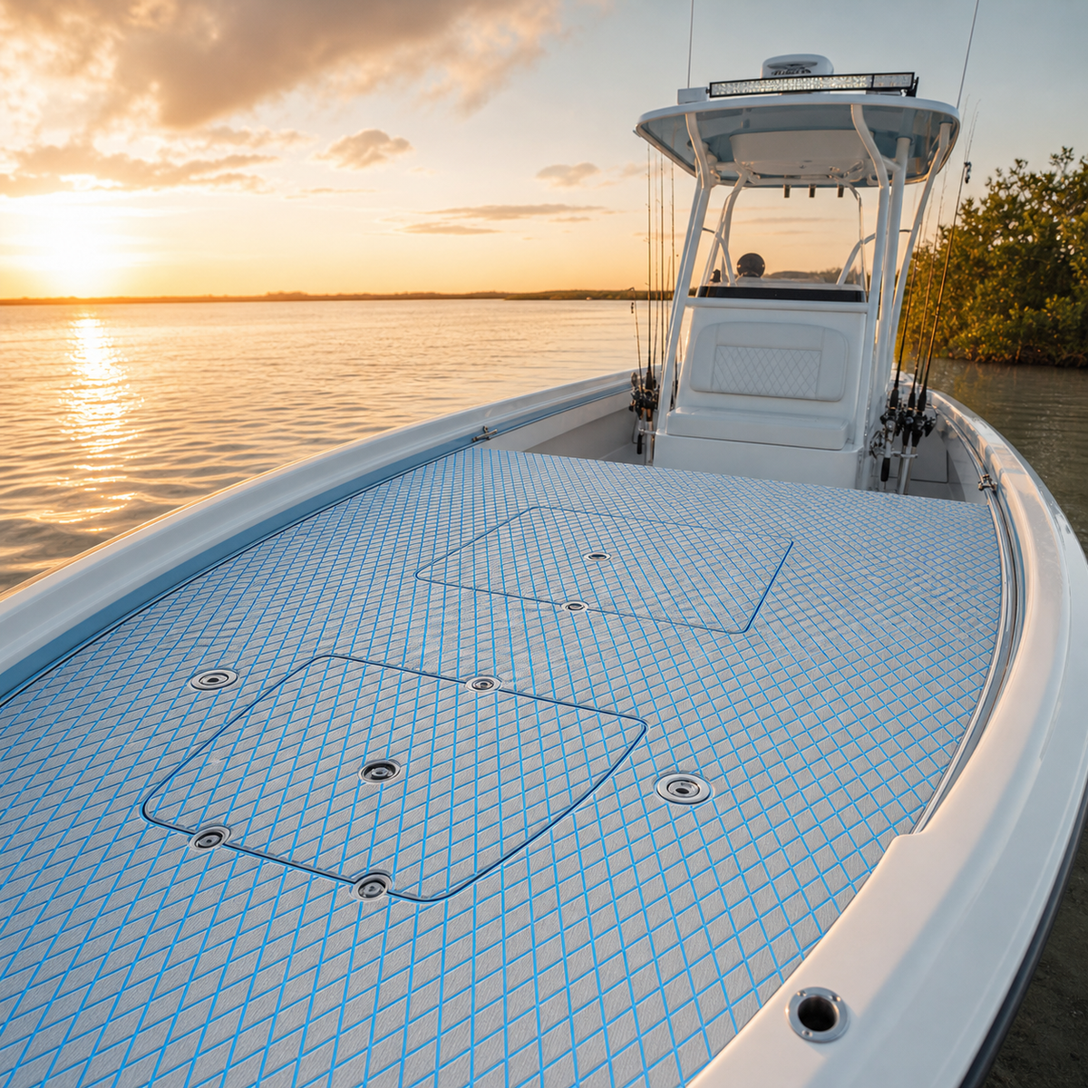 White center-console fishing boat near a mangrove shoreline at sunset with light gray deck flooring and blue diamond lines