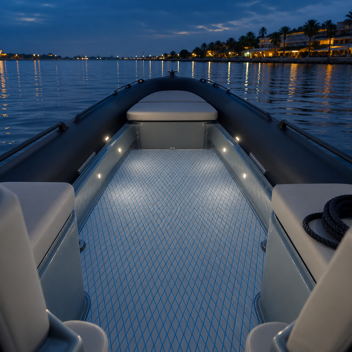 Light gray deck flooring with blue diamond lines inside a rigid inflatable boat at dusk