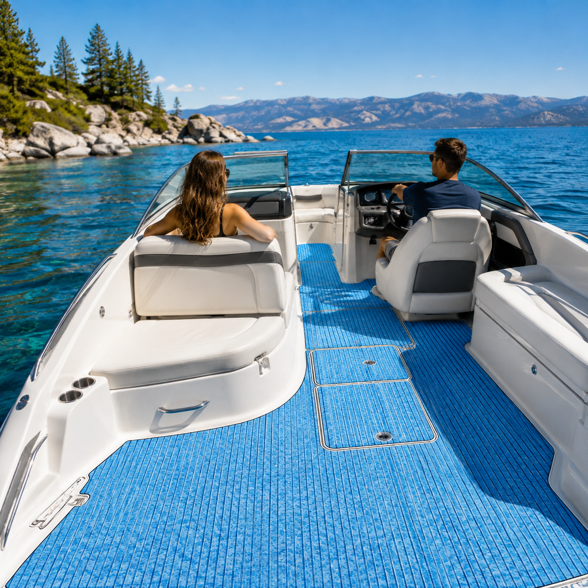 Blue straight-groove flooring in an open-bow runabout cockpit with a split windshield, helm, passenger seating, and lake shoreline